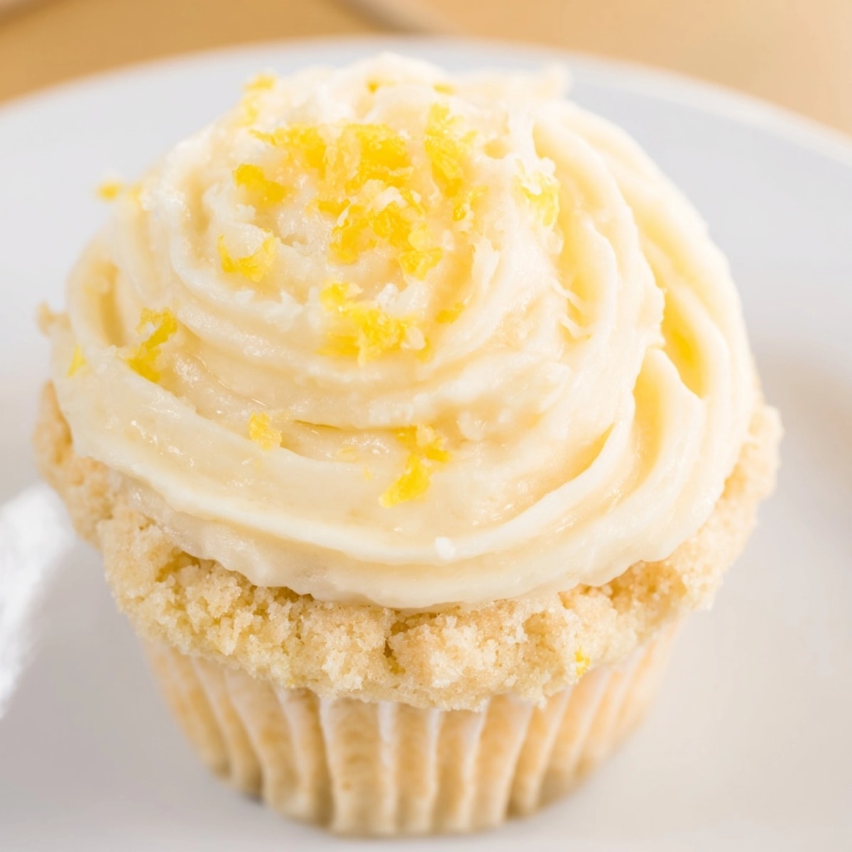 Close-up of moist lemon cupcakes with swirls of tangy buttercream frosting.