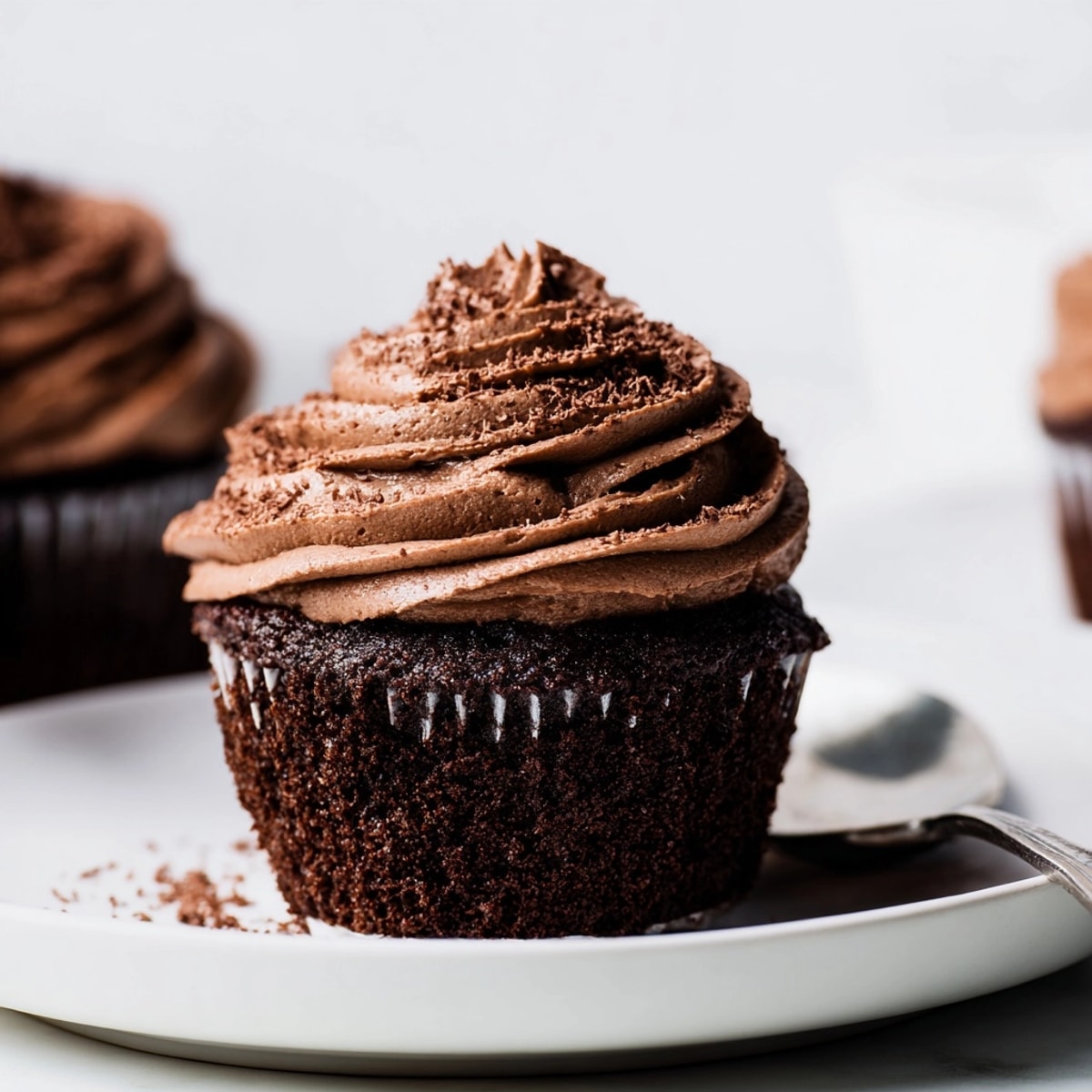 A batch of freshly baked, dark chocolate cupcakes cooling, promising a sweet, homemade treat.