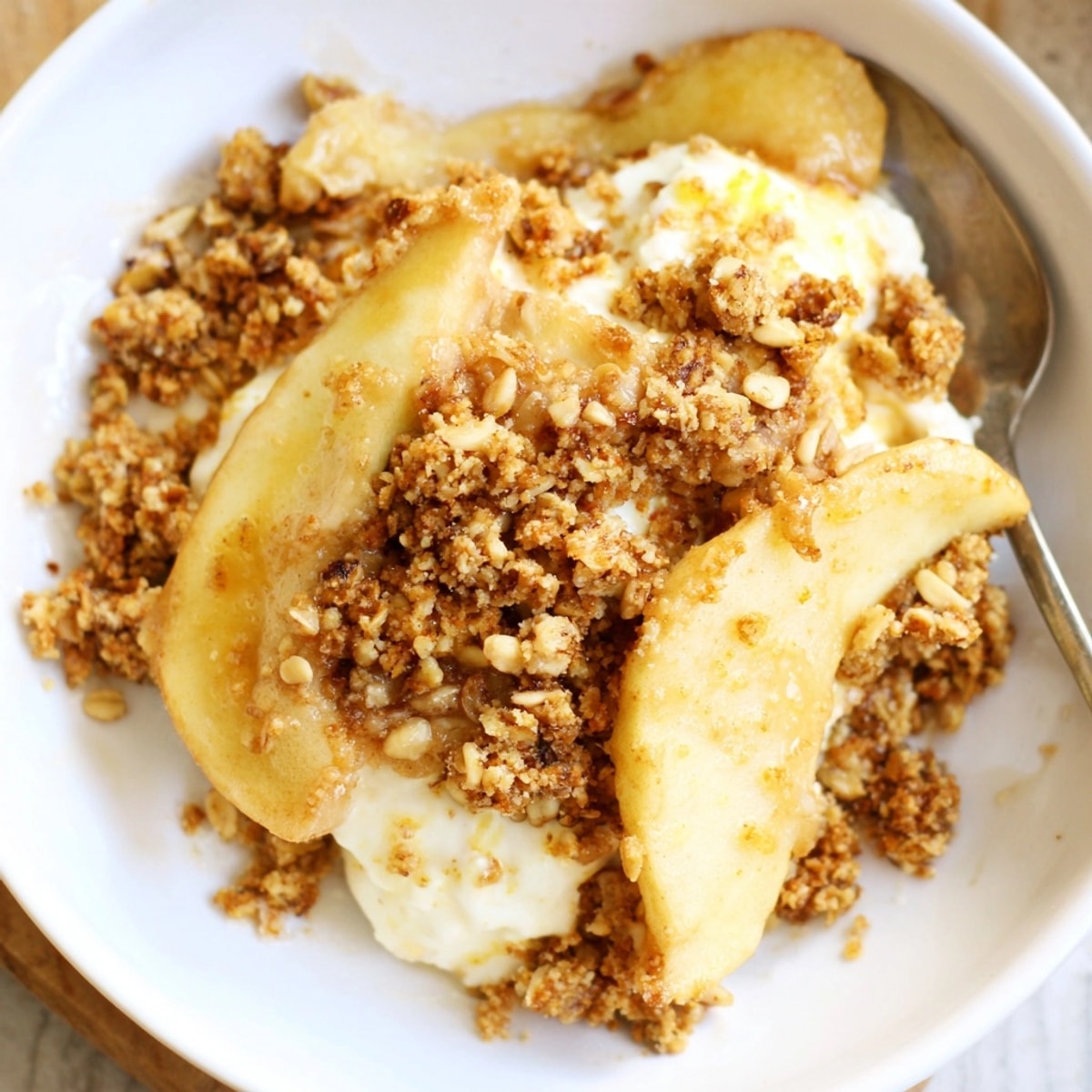 Golden brown Ricotta Apple Granola Crisp bubbling in a baking dish, ready to serve.
