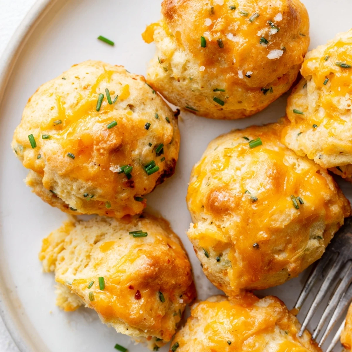 Savory Cheesy Pretzel Chili Garlic Biscuit Muffin Balls, golden brown and fluffy.  