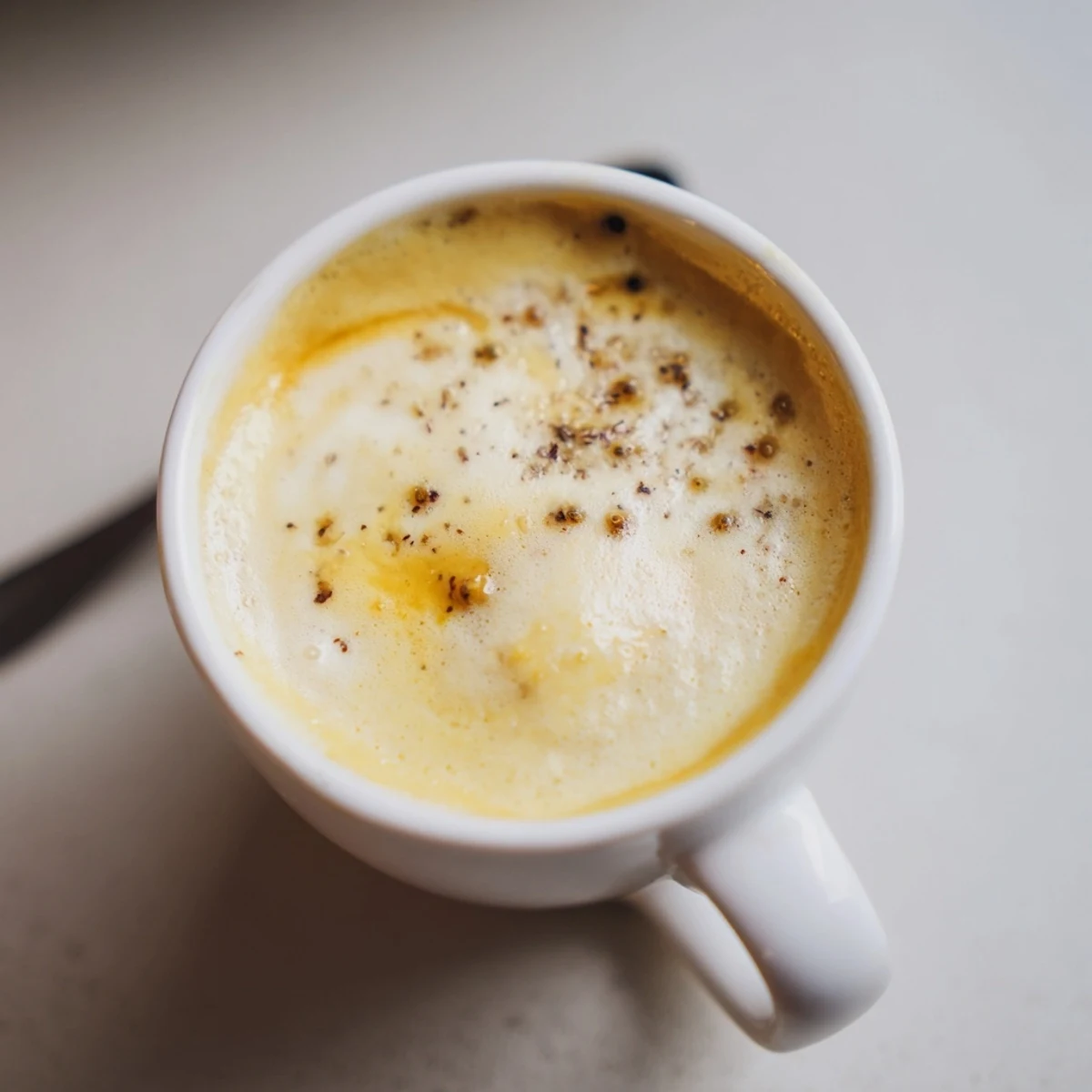 Savory onion latte topped with creamy froth, perfect for adventurous coffee lovers.  