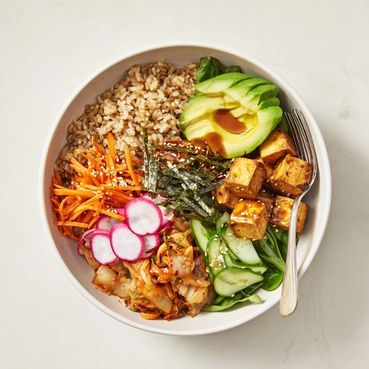 Nourishing Fermented Vegetable Bowl drizzled with ginger dressing and garnished with sesame seeds.