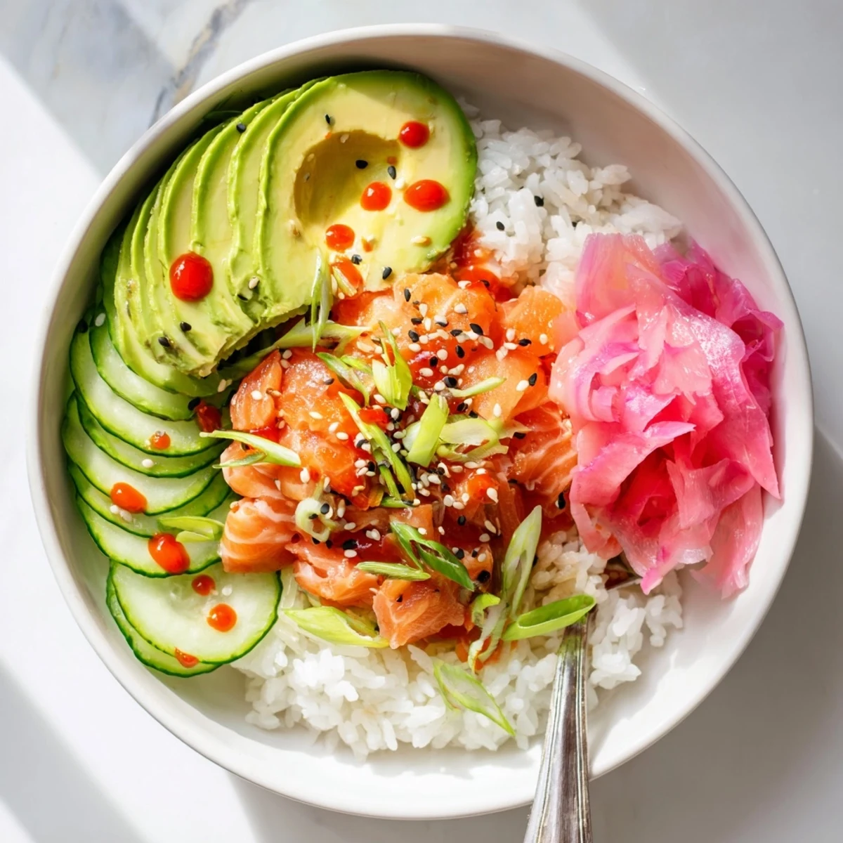 Revive leftover salmon in a delicious rice bowl, garnished with pickled ginger and scallions.