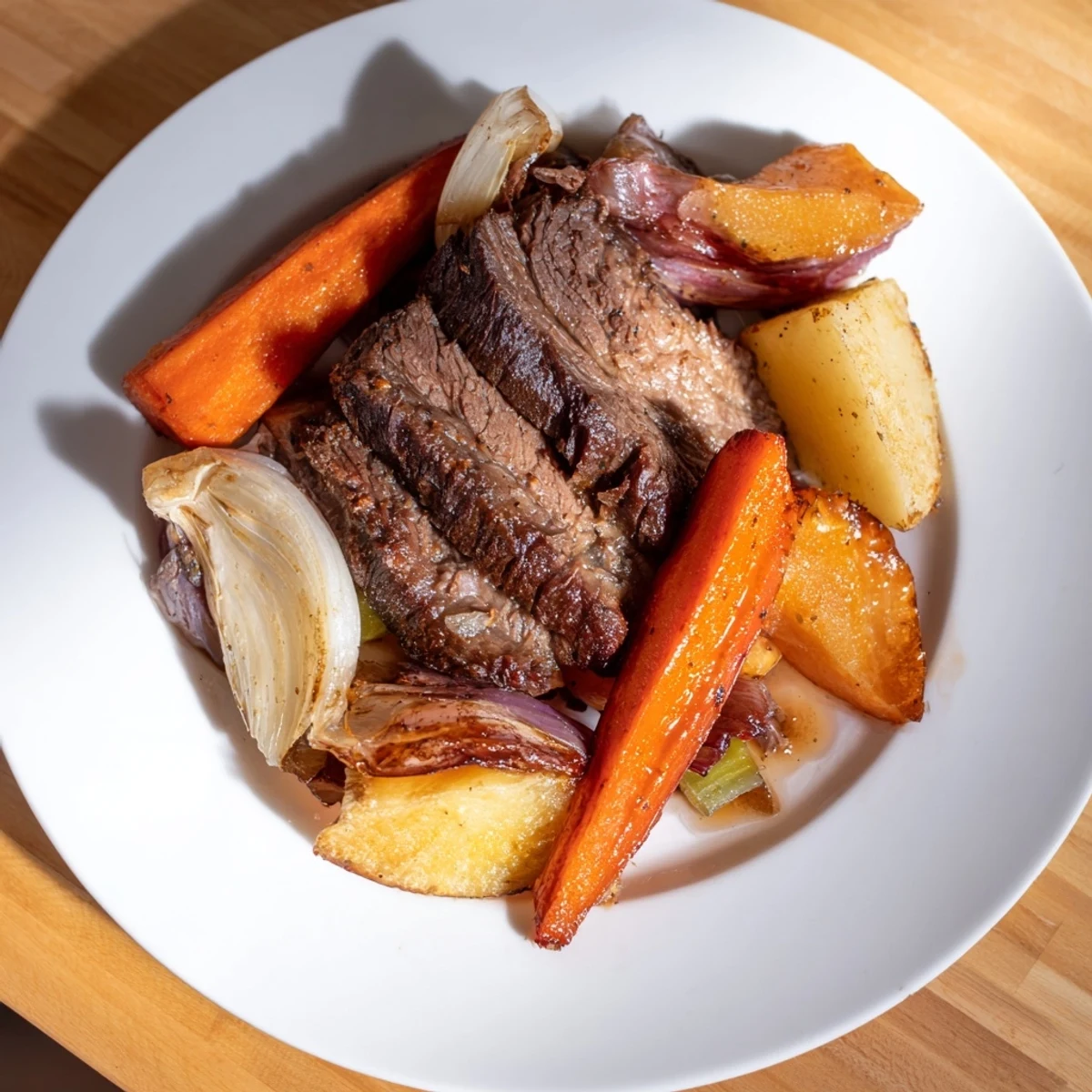 Savory Sunday Pot Roast adorned with vibrant carrots and golden potatoes, perfect for sharing.  