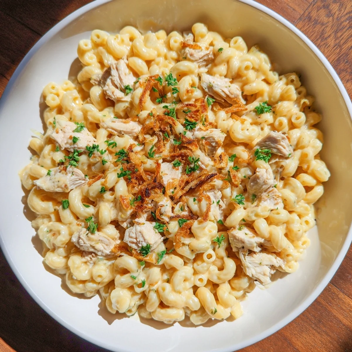 Golden, steaming One-Pot Honey BBQ Chicken Mac and Cheese, with a swirl of honey BBQ sauce, a family favorite.