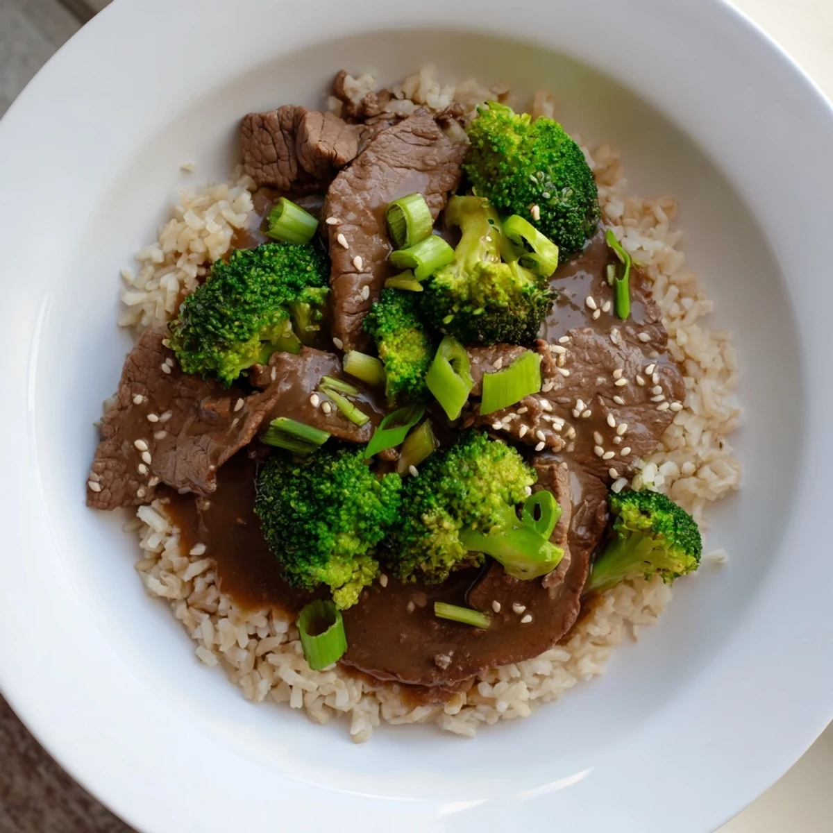 Tender slow-cooker Beef & Broccoli: savory sauce coats the beef and broccoli served over fluffy brown rice.