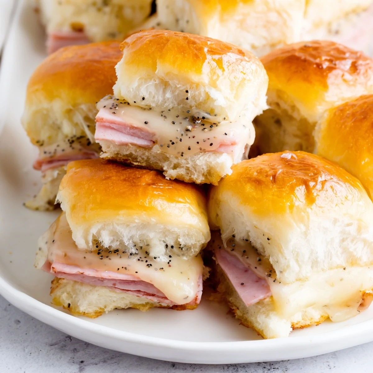 Delicious, melty Baked Ham and Cheese Party Sliders with a buttery glaze, ready for hungry guests to enjoy.