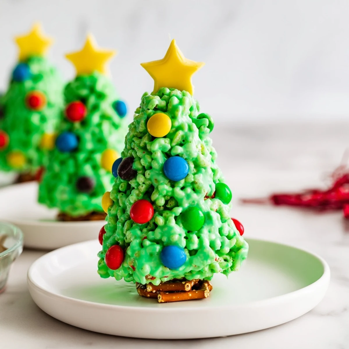 Festive green Christmas Tree Rice Crispy Treats sprinkled with colorful candies, perfect for the holidays.