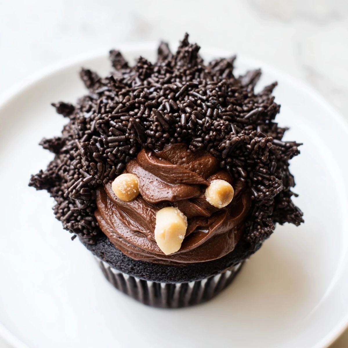 A delicious Hedgehog Cupcake Tower is presented, with chocolate buttercream and adorable hedgehog faces on top.