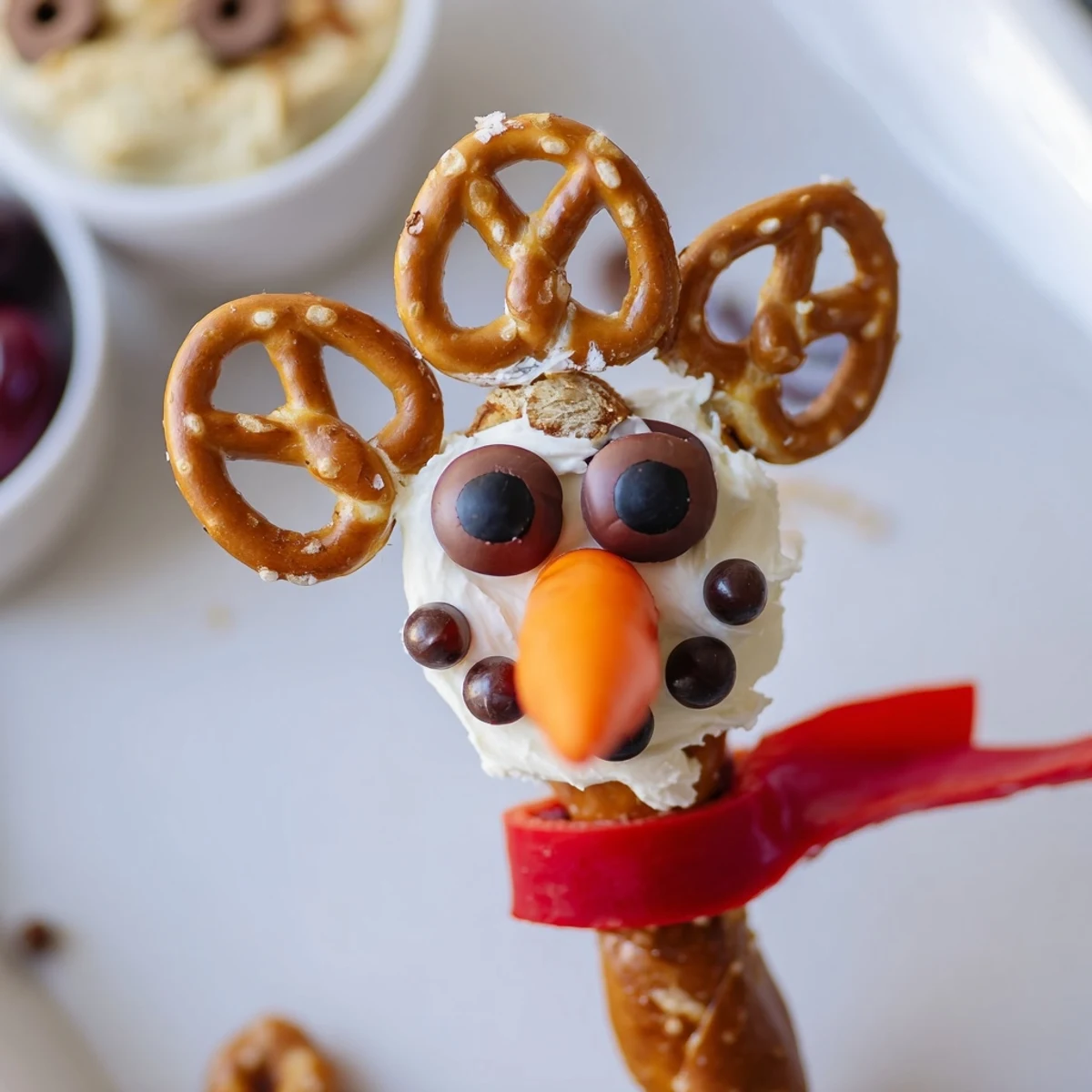 Snowman pretzel and dip platter, a festive appetizer of pretzel snowmen and creamy, delicious dips.