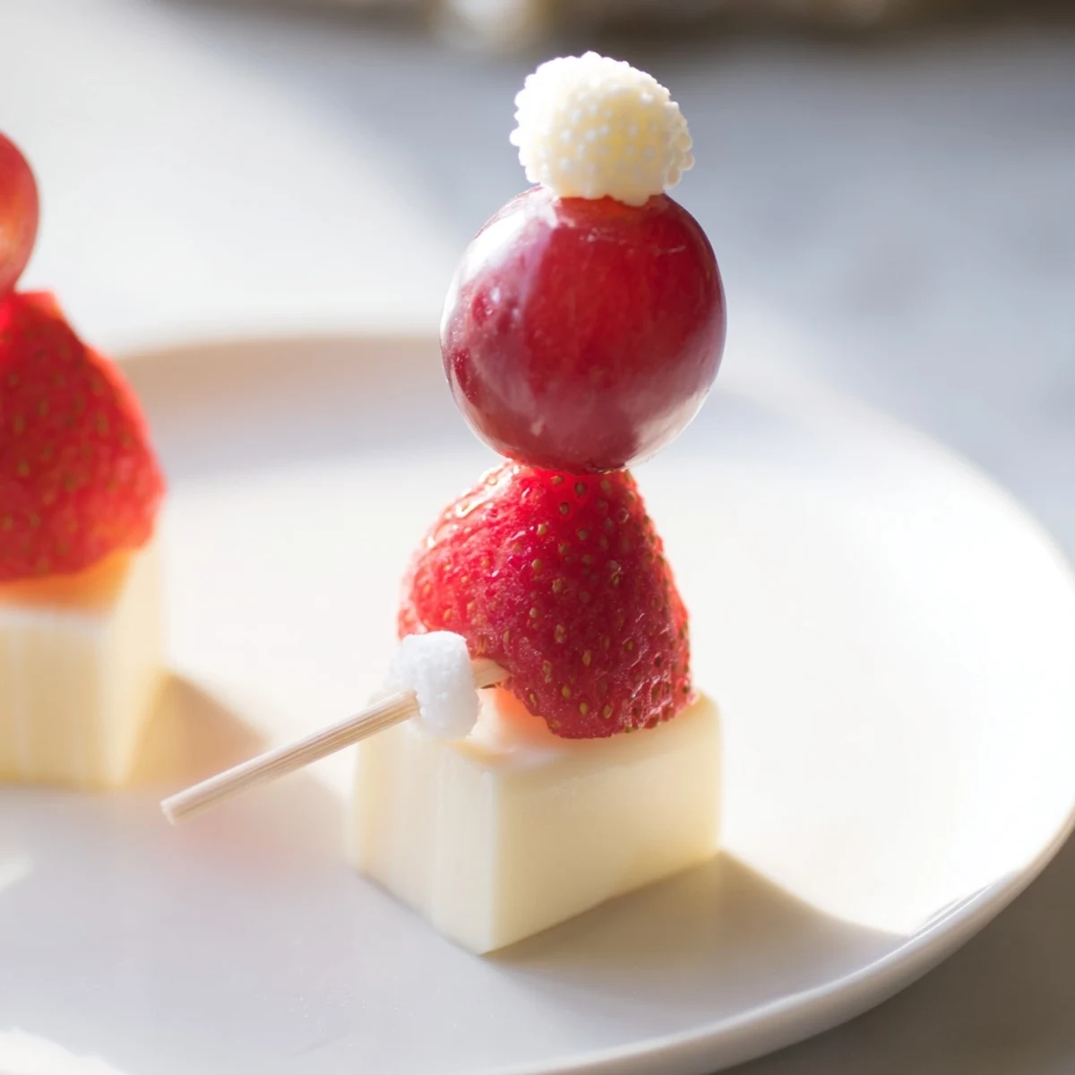 Vibrant Santa Hat Fruit and Cheese Platter with juicy strawberries and creamy mozzarella cheese.