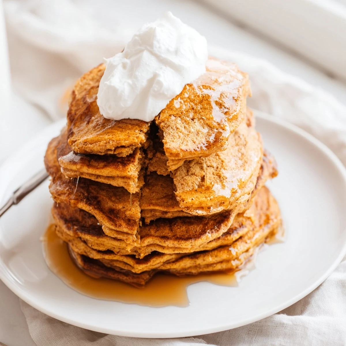 Delicious, homemade pumpkin spice pancakes, cooked until golden brown, offering warm spice aromas.