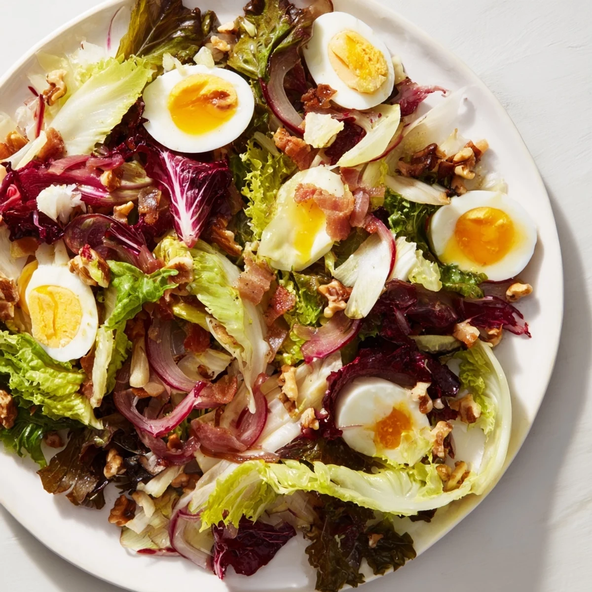 Warm Bitter Greens Salad with Warm Bacon Dressing, featuring wilted greens with crispy bacon and a savory vinaigrette.