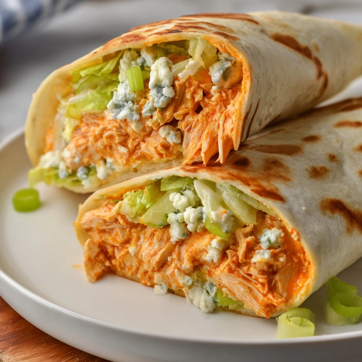A close-up shot of a flavorful Buffalo Chicken Dip Wrap, ready to eat with a warm, crispy exterior.