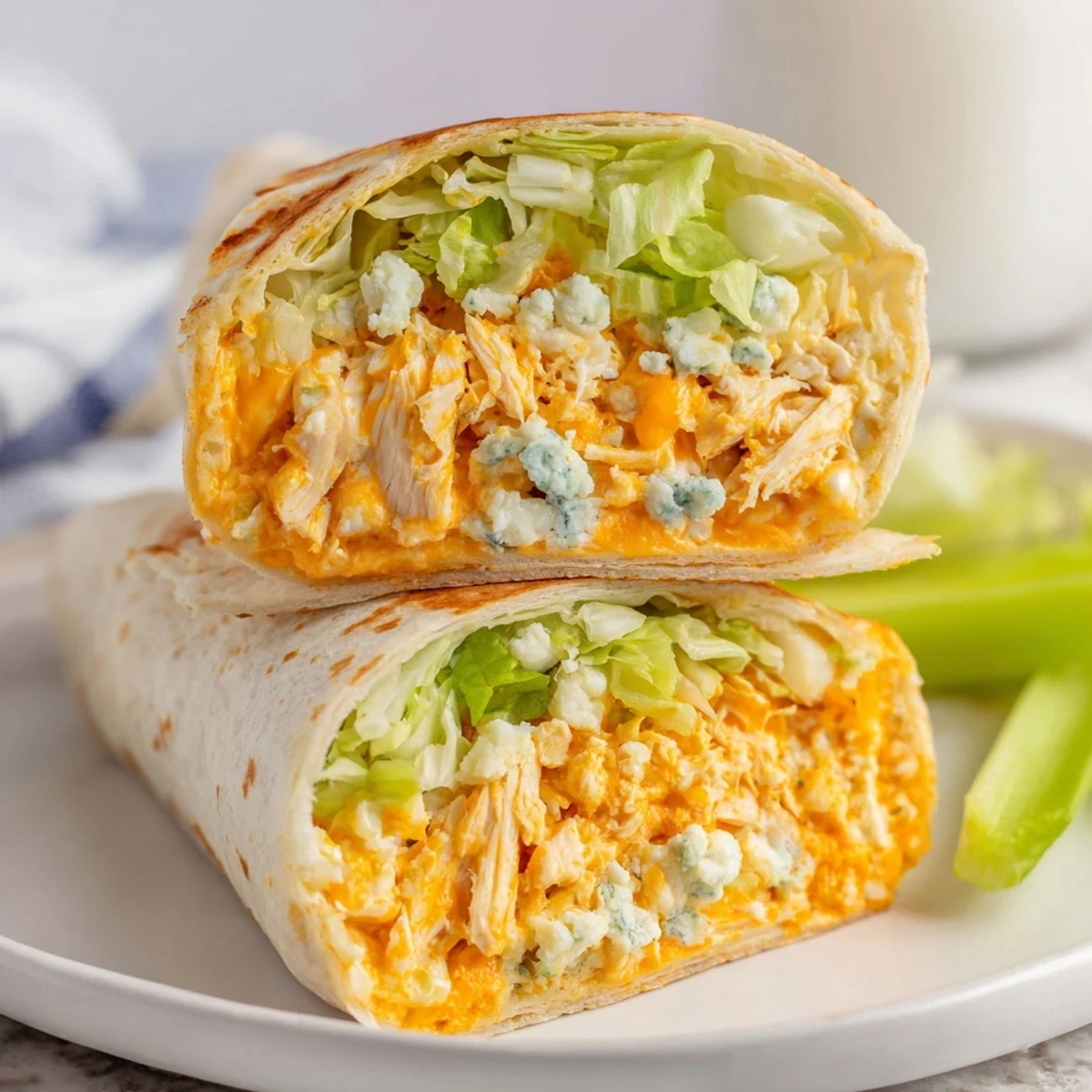 Enjoy this handheld Buffalo Chicken Dip Wrap, packed with cheesy, saucy chicken and fresh romaine lettuce.