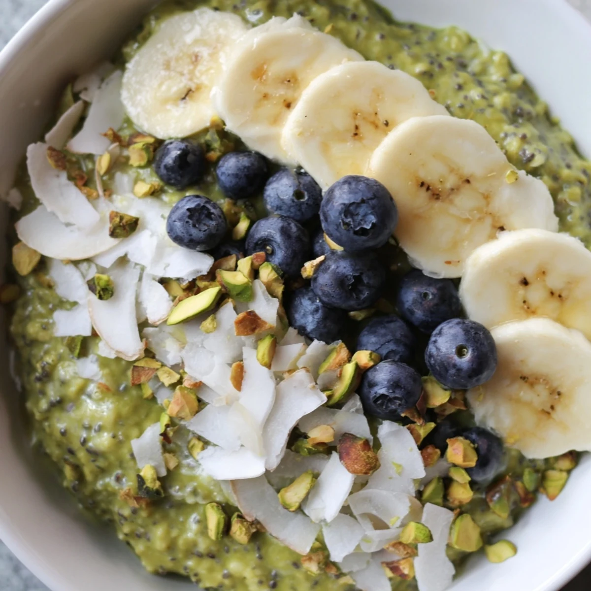 Creamy Matcha Overnight Oats layered with fresh berries, offering a delightful and refreshing breakfast.