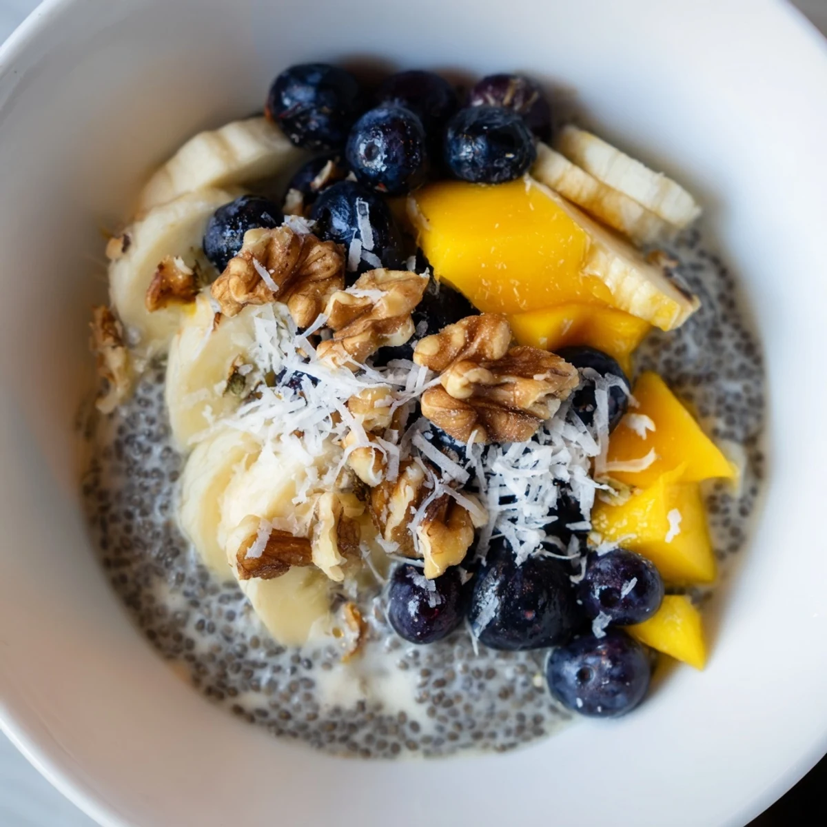 Creamy chia seed pudding with fresh berries and coconut flakes, ready to eat.