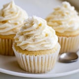 Close-up of a batch of freshly baked vanilla cupcakes, revealing their soft texture.