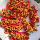 Golden-brown Cajun Turkey Stuffed Sweet Peppers recipe, savory and colorful on a sheet pan.