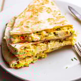 Scrumptious Ricotta Cheddar Breakfast Quesadilla slices, ready to eat, showcasing a delightful cheese pull.