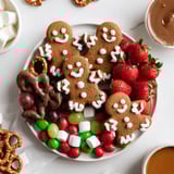 A visually stunning gingerbread man cookie board, perfect for sharing at holiday parties with family.