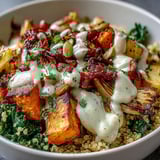 Steaming Hearty Winter Grain Bowl topped with colorful roasted vegetables and crunchy pumpkin seeds