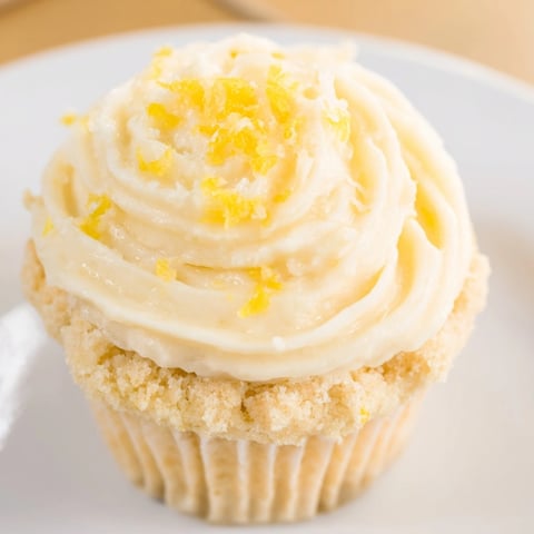 Close-up of moist lemon cupcakes with swirls of tangy buttercream frosting.