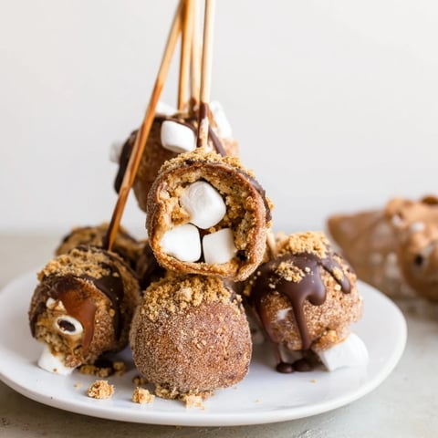 Fluffy Smores Churro Cake Pancake Pops coated in cinnamon sugar, perfect for breakfast.  