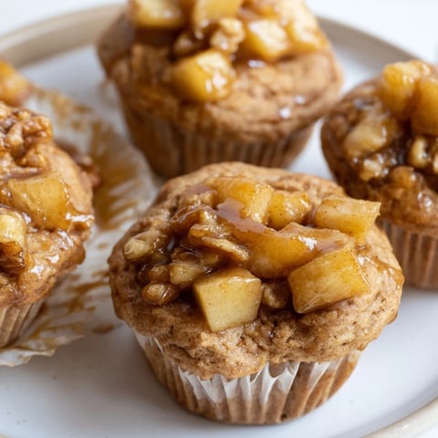 Tender Maple Ginger Caramel Apple Pancake Muffins with warm, caramelized apple filling.  