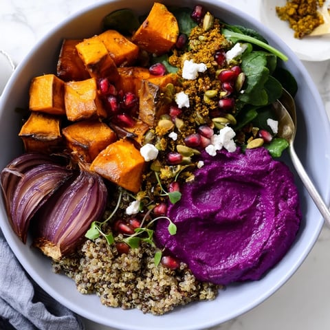 A colorful Spiced Winter Bowl filled with roasted veggies and ube-coconut puree.  