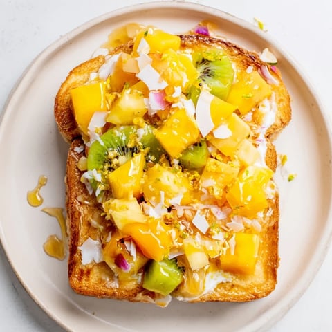 Vibrant Yogurt-Custard Toast topped with tropical fruits for a refreshing breakfast.  