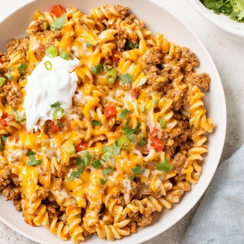 Golden, cheesy taco pasta skillet, a bubbling one-pan wonder ready for your dinner table.