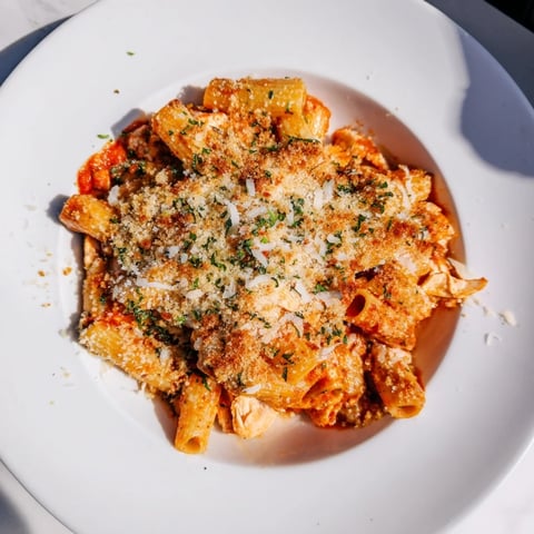 Baked Chicken Parmesan Pasta bubbling with melted cheese and golden, crispy breadcrumb topping.