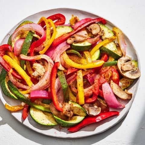 Steaming veggie skillet fajitas, showcasing colorful peppers and onions, ready to fill warm tortillas for dinner.