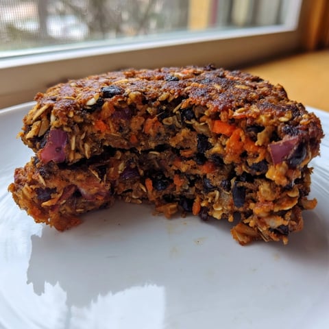 Golden-brown black bean burgers ready to be enjoyed, served atop a toasted bun with fresh toppings.