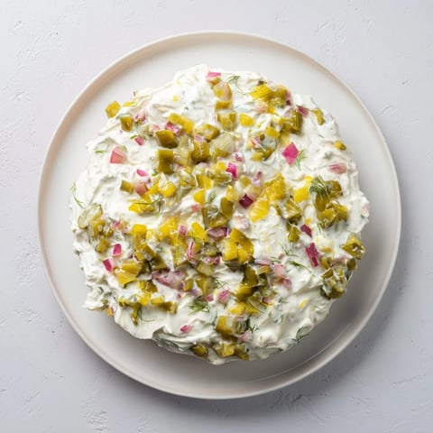 Creamy Sweet and Sour Pickle Relish Dip served with a pile of crispy potato chips for dipping.