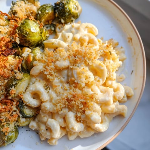Sheet pan mac and cheese with Brussels sprouts, golden-brown and bubbling hot right from the oven.