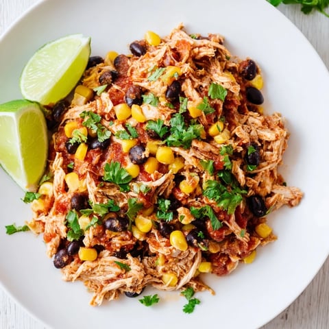 Tender, slow cooker salsa chicken, deliciously shredded and ready for taco night with vibrant toppings.