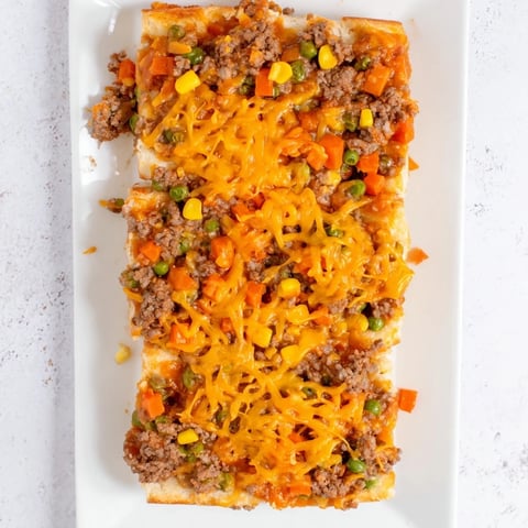 Golden, bubbly 5-Ingredient Sloppy Joe Casserole, a family favorite, ready for scooping and enjoying.
