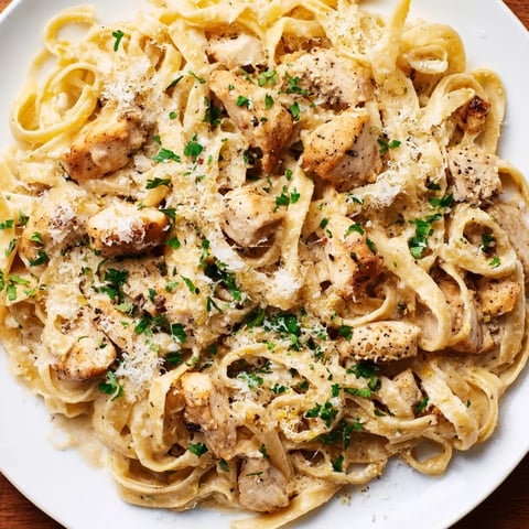 Creamy Cowboy Butter Chicken Pasta: a close-up shows tender chicken in a rich, buttery sauce with pasta.
