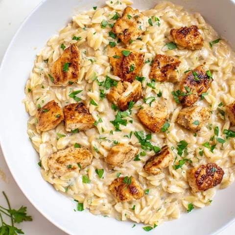 One-Pot Cajun Chicken Alfredo Orzo, a creamy skillet brimming with tender chicken and flavorful pasta.