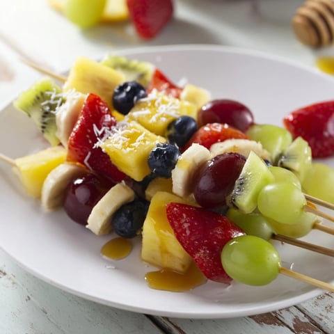 Vibrant Easy Festive Fruit Kabobs, showcasing colorful fruit artfully arranged on skewers, ready to enjoy.