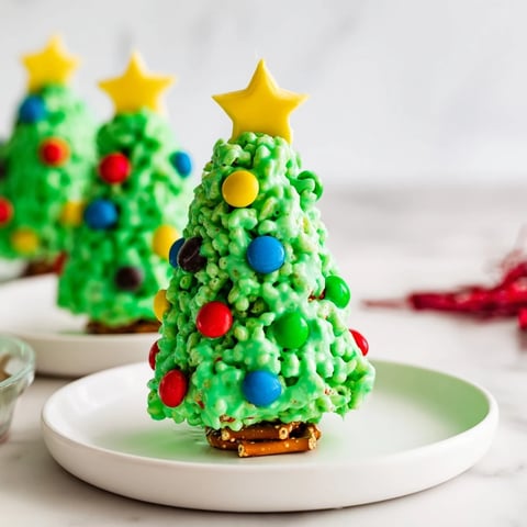 Festive green Christmas Tree Rice Crispy Treats sprinkled with colorful candies, perfect for the holidays.