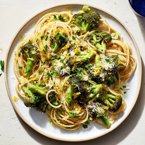 Golden-brown roasted garlic lemon broccoli angel hair pasta, a zesty vegetarian dinner option.