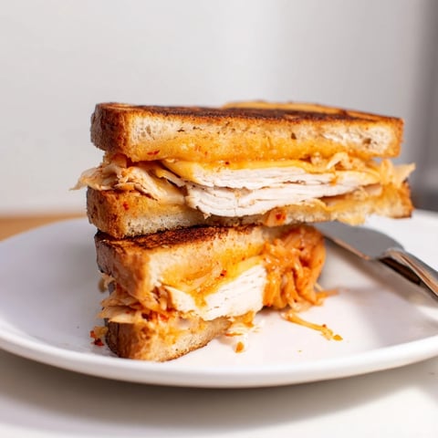 Golden, cheesy Kimchi Turkey & Cheddar Toasted Grilled Cheese, a melty, savory sandwich treat.