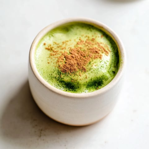Steaming Cinnamon Maple Oat Milk Matcha Latte in a mug, a cozy, vegan recipe for chilly days.