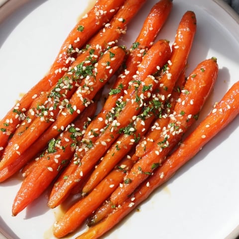 Honey soy roasted carrots glistening with the perfect glaze, ready for serving this colorful side.