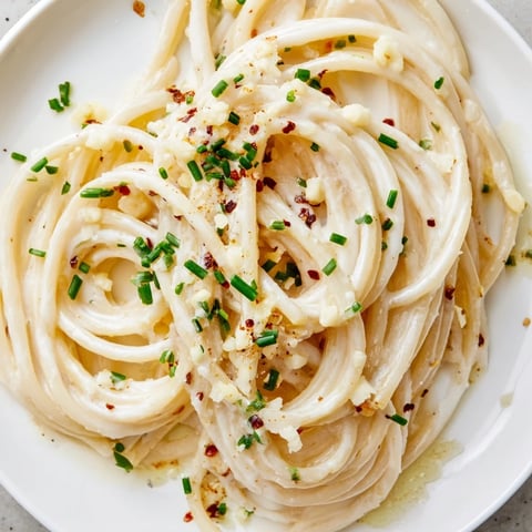 Steaming bowl of Miso Butter Pasta, glistening noodles coated in a rich, umami sauce.
