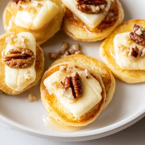 Fluffy golden Pancake Brie Bites, a perfect brunch appetizer, overflowing with melted brie.