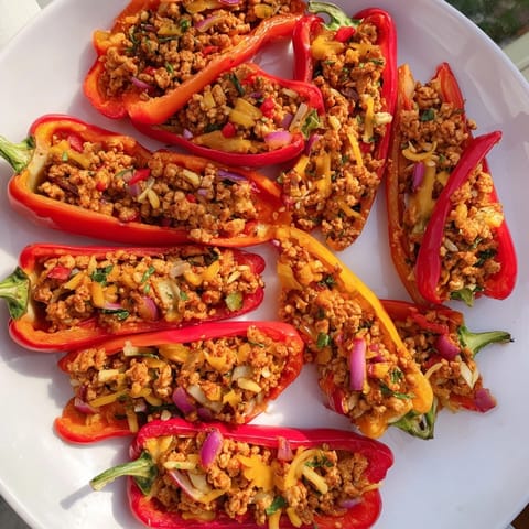 Golden-brown Cajun Turkey Stuffed Sweet Peppers recipe, savory and colorful on a sheet pan.